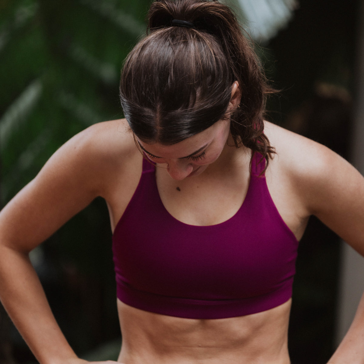 Woman wearing a purple sports bra outdoors